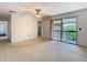 Spacious bedroom with sliding glass doors to balcony with a ceiling fan, and neutral colors at 6323 Newtown Cir # 23A1, Tampa, FL 33615