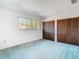 Bedroom with bright natural light, a window view, and closet storage at 6323 Newtown Cir # 23A1, Tampa, FL 33615