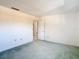 Bedroom showcasing neutral carpet and view into the hallway at 6323 Newtown Cir # 23A1, Tampa, FL 33615