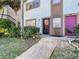 Close up exterior of units A1 and A2 showcasing landscaping, front doors, and muted exterior paint at 6323 Newtown Cir # 23A1, Tampa, FL 33615