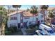 Exterior view of the townhomes featuring colorful front doors, mature palms, and ample parking at 6323 Newtown Cir # 23A1, Tampa, FL 33615