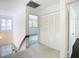 Hallway with carpeted floors and a view to a living room with neutral walls and large closet at 6323 Newtown Cir # 23A1, Tampa, FL 33615