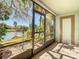 Screened-in lanai with tile flooring, water views, and outdoor access at 6323 Newtown Cir # 23A1, Tampa, FL 33615