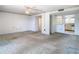 Open living room space leading into the hallway and kitchen area with a wet bar area at 6323 Newtown Cir # 23A1, Tampa, FL 33615