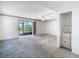 Living room with ceiling fan, sliding glass doors to patio, and a wet bar in the corner at 6323 Newtown Cir # 23A1, Tampa, FL 33615