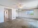 Open living space with access to the hallway, wet bar, and a large window providing natural light at 6323 Newtown Cir # 23A1, Tampa, FL 33615