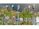 Aerial view of the waterfront home with a boathouse and well-maintained landscaping at 680 George S St, Tarpon Springs, FL 34688