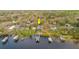 Aerial view of waterfront home with lush tree cover at 680 George S St, Tarpon Springs, FL 34688
