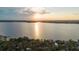 Gorgeous sunset view over the lake with lush trees on the shoreline at 680 George S St, Tarpon Springs, FL 34688