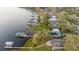 An aerial view showcasing the waterfront home and dock extending into the lake, and neighborhood docks at 680 George S St, Tarpon Springs, FL 34688