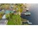 Stunning aerial view of a waterfront home with lush landscaping, private dock, and ample space for outdoor entertaining at 680 George S St, Tarpon Springs, FL 34688