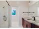 Bathroom with a large granite vanity, frameless glass shower, and modern fixtures at 680 George S St, Tarpon Springs, FL 34688