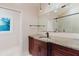 Bathroom featuring a vanity with granite countertop, dark wood cabinetry and modern fixtures at 680 George S St, Tarpon Springs, FL 34688