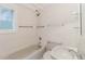 This bathroom features a shower and tub combination and a window for great natural light at 680 George S St, Tarpon Springs, FL 34688