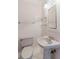 This bathroom features a pedestal sink, and a tiled wall and floor at 680 George S St, Tarpon Springs, FL 34688