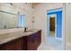 Bathroom featuring a vanity with granite countertop, dark wood cabinetry and modern fixtures at 680 George S St, Tarpon Springs, FL 34688