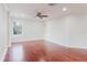 Bedroom with hardwood floors, neutral walls, and bright natural light at 680 George S St, Tarpon Springs, FL 34688