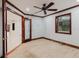 This bedroom boasts custom trim, tile flooring, and a ceiling fan, providing a comfortable space at 680 George S St, Tarpon Springs, FL 34688