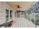 Expansive outdoor deck with stone accent wall, outdoor ceiling fans, and scenic views at 680 George S St, Tarpon Springs, FL 34688