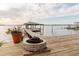 Scenic waterfront dock featuring a fire pit and a cozy seating area with relaxing water views at 680 George S St, Tarpon Springs, FL 34688