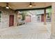 Charming exterior featuring a stone wall, wood deck, detached garage, and separate guest house at 680 George S St, Tarpon Springs, FL 34688
