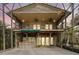 Spacious two-story screened outdoor area with stone accents, balcony, and outdoor bar at 680 George S St, Tarpon Springs, FL 34688