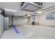 Spacious garage with pegboard walls, epoxy floors, and ample storage and lighting at 680 George S St, Tarpon Springs, FL 34688