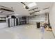 Well-lit garage with a pegboard wall, epoxy flooring, storage cabinets, and an automatic door at 680 George S St, Tarpon Springs, FL 34688