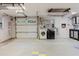 Spacious two-car garage featuring modern washer, dryer, storage, and ample workspace at 680 George S St, Tarpon Springs, FL 34688