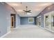 Spacious living room with high ceilings, skylight and natural light from French doors and a large window at 680 George S St, Tarpon Springs, FL 34688