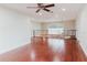 Spacious living room with hardwood floors, ceiling fan, and elegant railing overlooking the floor below at 680 George S St, Tarpon Springs, FL 34688