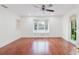 Sunlit living room with bay window, wood floors, and neutral walls at 680 George S St, Tarpon Springs, FL 34688