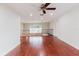 Living room with hardwood floors, ceiling fan, and elegant railing overlooking the floor below at 680 George S St, Tarpon Springs, FL 34688