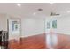 Bright living room featuring hardwood floors, ceiling fan, recessed lighting, and natural light from the windows at 680 George S St, Tarpon Springs, FL 34688