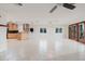 Spacious living room featuring light wood kitchen, tile floors, and access to a large outdoor area at 680 George S St, Tarpon Springs, FL 34688