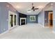 Living room featuring vaulted ceiling, a fireplace, and access to the porch via French doors at 680 George S St, Tarpon Springs, FL 34688