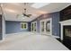 Living room featuring vaulted ceiling, fireplace, French doors to the porch, creating an inviting space at 680 George S St, Tarpon Springs, FL 34688