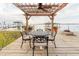 Waterfront patio featuring an outdoor dining area under a pergola with ceiling fan overlooking the lake at 680 George S St, Tarpon Springs, FL 34688