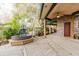 Covered outdoor patio featuring stone accents, a fountain, and decorative vegetation at 680 George S St, Tarpon Springs, FL 34688
