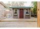Charming shed with wood door, windows, flower boxes, and a deck for outdoor relaxation at 680 George S St, Tarpon Springs, FL 34688