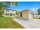 Exterior view of a two-story home and detached garage with concrete driveway and grassy backyard at 7125 6Th N Ave, St Petersburg, FL 33710