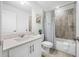 Bright bathroom with tub and shower combo, with a decorative shower curtain and white vanity at 7125 6Th N Ave, St Petersburg, FL 33710