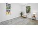 Bright bedroom with neutral chair and decor, featuring large windows and tile floors at 7125 6Th N Ave, St Petersburg, FL 33710