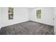 Empty carpeted bedroom with white walls and trim and natural light from windows at 7125 6Th N Ave, St Petersburg, FL 33710