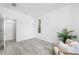 Bright bedroom featuring closet and neutral decor, including tile floors and a neutral chair at 7125 6Th N Ave, St Petersburg, FL 33710