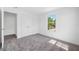 Neutral bedroom featuring a closet, window, and carpet flooring at 7125 6Th N Ave, St Petersburg, FL 33710