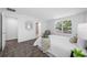 Airy bedroom featuring a large window, closet, and carpet flooring at 7125 6Th N Ave, St Petersburg, FL 33710