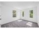 Spacious bedroom filled with natural light from three windows, carpet flooring at 7125 6Th N Ave, St Petersburg, FL 33710