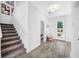 Open entryway with tile flooring, staircase, and a clear view to the front door at 7125 6Th N Ave, St Petersburg, FL 33710