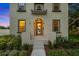 Detailed exterior shot showcasing the front entrance, windows with gray trim, and lush landscaping surrounding the home at 7125 6Th N Ave, St Petersburg, FL 33710